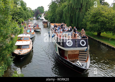 Hurley, Berkshire, UK. 17th July, 2019. A flotilla of boats including the Waterman follow the swan uppers as they leave Hurley Lock on day three of Swan Upping 2019. A week long survey of the the swans on the River Thames, from Sunbury in Surrey to Abingdon in Oxfordshire. The Royal Swan Uppers, who wear the scarlet uniform of Her Majesty The Queen, travel in traditional rowing skiffs together with Swan Uppers from the Vintners' and Dyers' livery companies. Credit: Julia Gavin/Alamy Live News Stock Photo