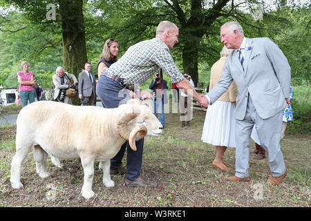 The Prince of Wales and the Duchess of Cornwall (right) attending a celebration of the 70th anniversary of the National Parks and Access to the Countryside Act at a Big Picnic in Exmoor National Park, as part of their visit to Devon. Stock Photo