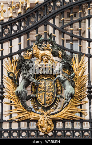 London, UK - July 8th 2014: Vertical close-up view of golden Buckingham Palace gates. Artwork  done by Bromsgrove Guild of Applied Arts Stock Photo