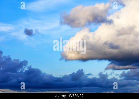 Thunderclouds float in the sky, gathering together. Stock Photo