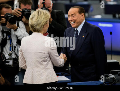 Silvio Berlusconi (l) from Italy, Member of the European Parliament, congratulates Ursula von der Leyen during the announcement of the election results at the Chamber.German defence minister Ursula von der Leyen was narrowly elected as the president of the European Commission on July 16, after winning over sceptical lawmakers. The 60-year-old conservative was nominated to become the first woman in Brussels' top job last month by the leaders of the bloc's 28 member states, to the annoyance of many MEPs. Stock Photo