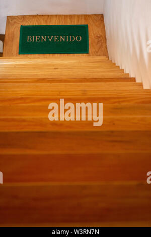 Welcome mat on wood stairs view Stock Photo