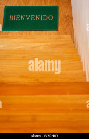 Welcome mat on wood stairs view close up Stock Photo