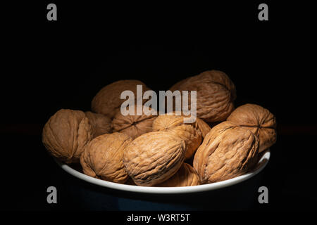 Delicious walnuts on black background Stock Photo