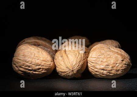 Delicious walnuts on black background Stock Photo