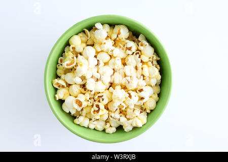 Fried popcorn in a green bowl. White background. Stock Photo