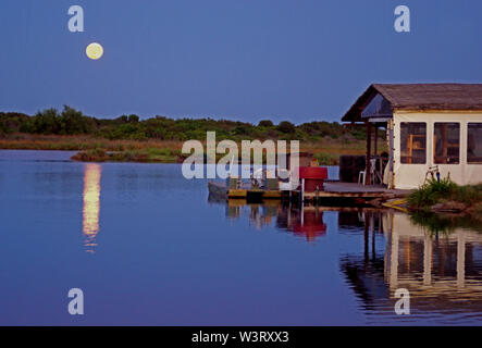 The moon rises on the pond of San Teodoro, Sardinia, Italy Stock Photo