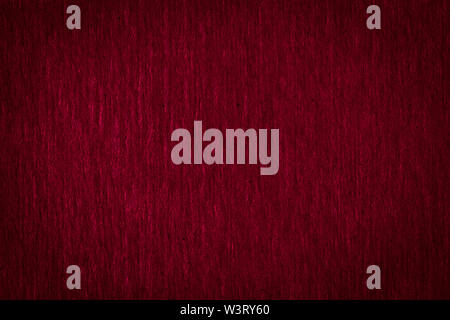 Abstract texture of a rough dark burgundy paper background and copy space for text. Macro fiber paper. Stock Photo