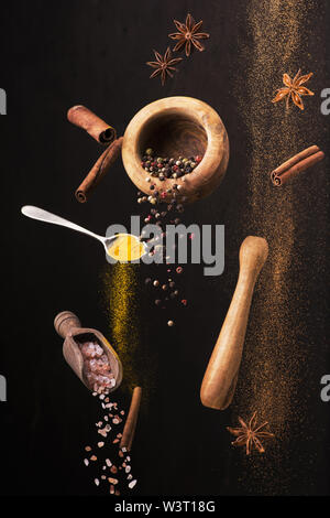 vibrant still life with some types of spices with different colors and flavors in the dark background Stock Photo