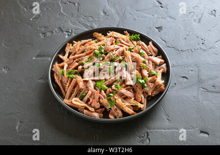 Slow cooked pulled pork for sandwiches on plate Stock Photo