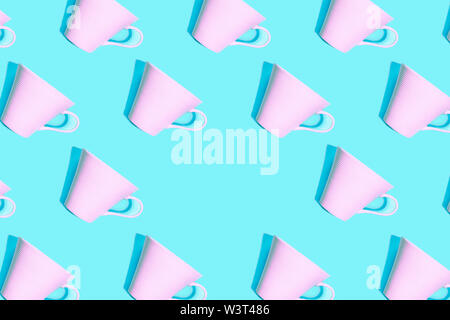 Coffee pattern of pink cup for coffee on bright blue background. Stock Photo