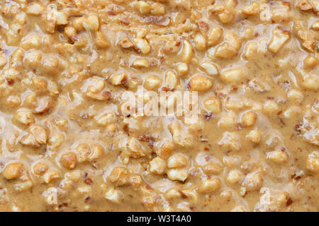 Crunchy Peanut Butter on toast - full frame in close up. Stock Photo