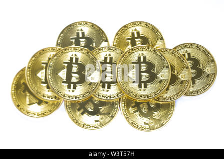 A pile of bitcoins, symbolic of the cryptocurrency traded on the internet, isolated on white. Stock Photo