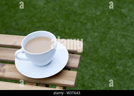Cup & Saucer of Flat White Coffee with Milk Outside Stock Photo