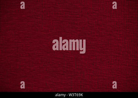 Texture of real burgundy knitwear, textile background. Stock Photo