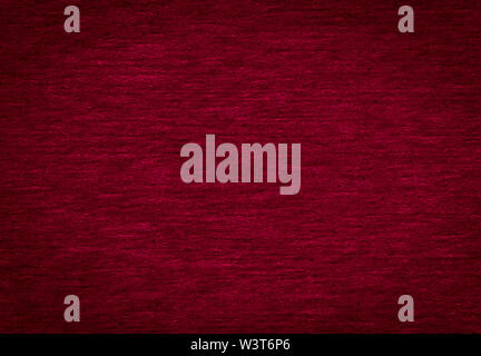 Abstract texture of a rough dark burgundy paper background and copy space for text. Macro fiber paper. Stock Photo