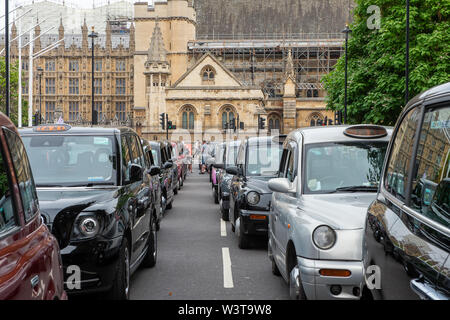 Taxi Driver Protest, Westminster Square, London, UK. 17th July, 2019. Taxi drivers brought Westminster and the the surrounding area to a halt this afternoon as part of their weekly protest by blocking the roads  around Parliament Square with their black cabs. TFL plan to stop taxi drivers from using some roads around London and London cabbies are not happy about it. Their message is 'Where buses go, taxis go'.  Credit: Maureen McLean/Alamy Live News Stock Photo