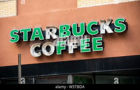 A distressed Starbucks coffee shop sign in Brooklyn in New York on Sunday, July 14, 2019. (© Richard B. Levine) Stock Photo