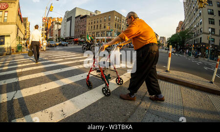 An elderly man crosses the street in the New York neighborhood of Chelsea on Tuesday, July 16, 2019. (© Richard B. Levine) Stock Photo