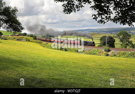 45690 Leander heads past Benson Hall near Oxenholme with a Cumbrian Mountain express. Stock Photo
