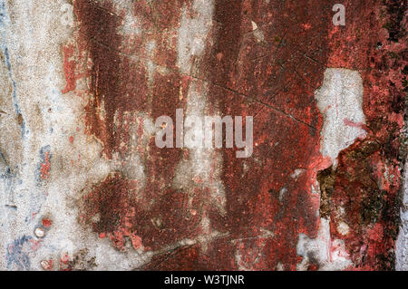 Original background of natural cement plaster on red textured wall with cracks. Stock Photo
