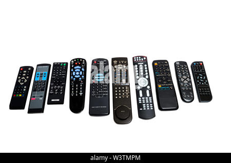Horizontal shot of a row of ten lined up dirty used remote controls.  Different sizes and button configurations.  White background. Stock Photo