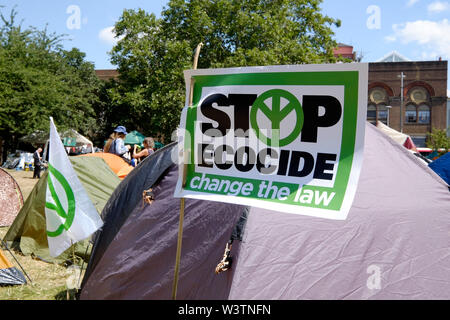 Activist's tent displays sign 'Stop Ecocide' at Extinction Rebellion's Summer Uprising Camp, Millennium Green, Waterloo. Stock Photo