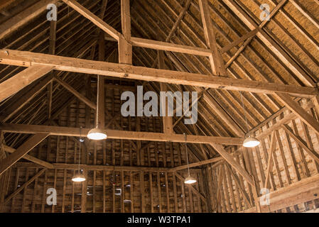 Inside view of old wooden roof wood structure with wooden beams in old barn Stock Photo