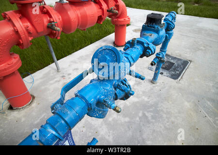 red and blue water pipes standpipes polk county utilities above ground access for water main and customer connections florida USA United States of Ame Stock Photo