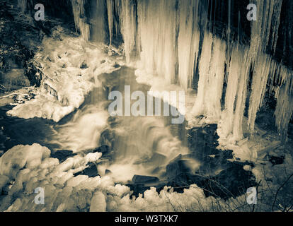 Duotone of a part frozen Grassy Creek Falls, near Little Switzerland, North Carolina, USA. Stock Photo