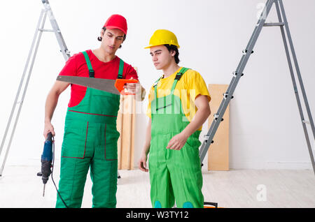 The two workers contractors working indoors Stock Photo