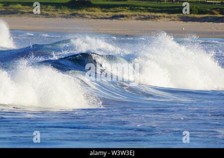Waves crashing onto a beach Stock Photo