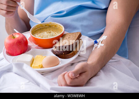 The male patient eating food in the hospital Stock Photo