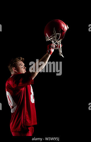 American football player cheering with arm up Stock Photo