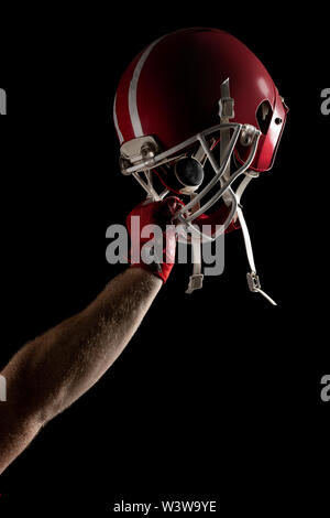 American football player cheering with arm up Stock Photo