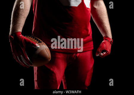 American football player standing with rugby ball Stock Photo