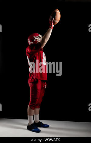 American football player cheering with arm up Stock Photo