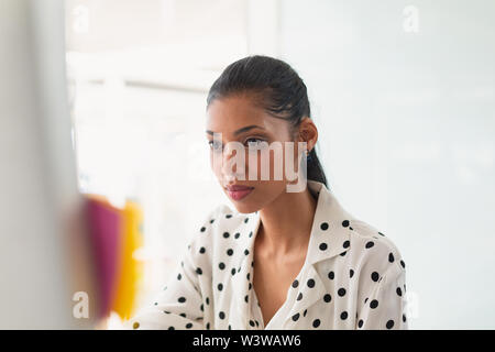 Female graphic designer working on at desk Stock Photo
