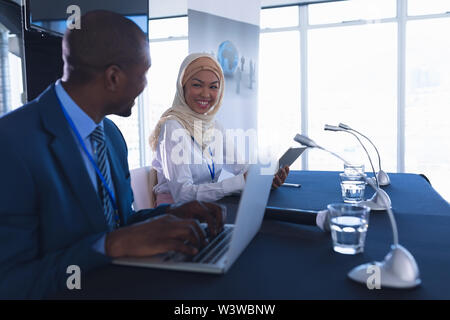 Business people sitting together at table in conference meeting Stock Photo