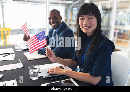 Business people sitting at conference registration table Stock Photo