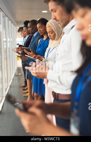 Business people using multimedia devices in business seminar Stock Photo