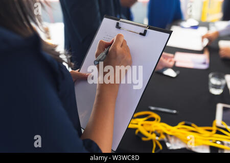 Businesswoman checking in at conference registration table Stock Photo