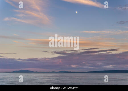 cloudy sunset and moon in strait of Georgia between Vancouver and Victoria. Stock Photo