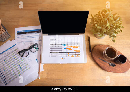 Top viw of office stuff with notepad, laptop and coffee cup mouse notepad top view shot. Stock Photo