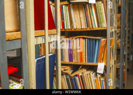 Blurred image of old books on bookshelves in library Stock Photo