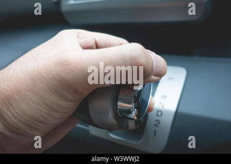 Hand on shifting automatic car gear to Drive Stock Photo
