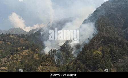 fire in mountain forest. aerial view forest fire and smoke on slopes hills. wild fire in mountains in tropical forest, Java Indonesia. natural disaster fire in Southeast Asia Stock Photo