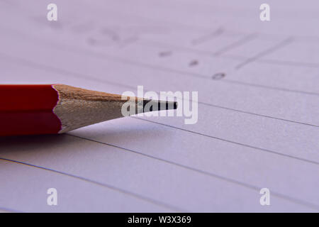 Red pencil with notebook on wooden table Save creative ideas on paper. Basic equipment before the computer. On the rustic table background - Image Stock Photo