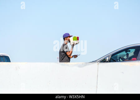 A man selling fruit drinks to tourists crossing the border from Mexico to the USA. Stock Photo