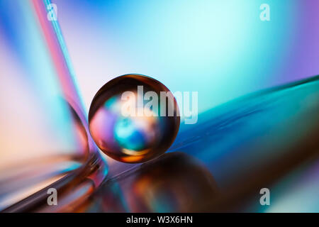 Small glass ball in abstract macro composition. Stock Photo